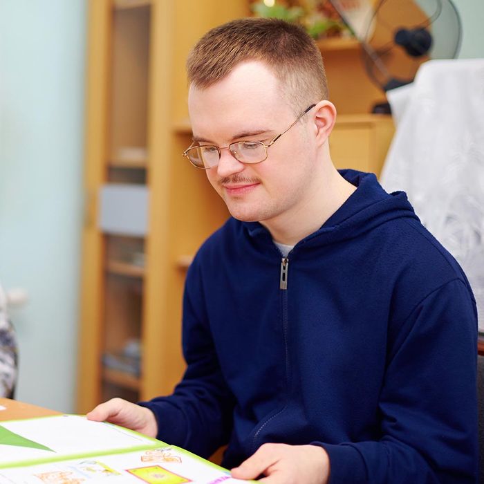 a young man with special needs reading a book